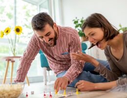 Couple playing board games at home