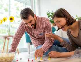 Couple playing board games at home