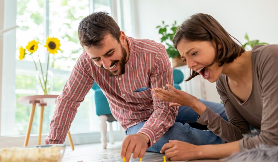 Couple playing board games at home