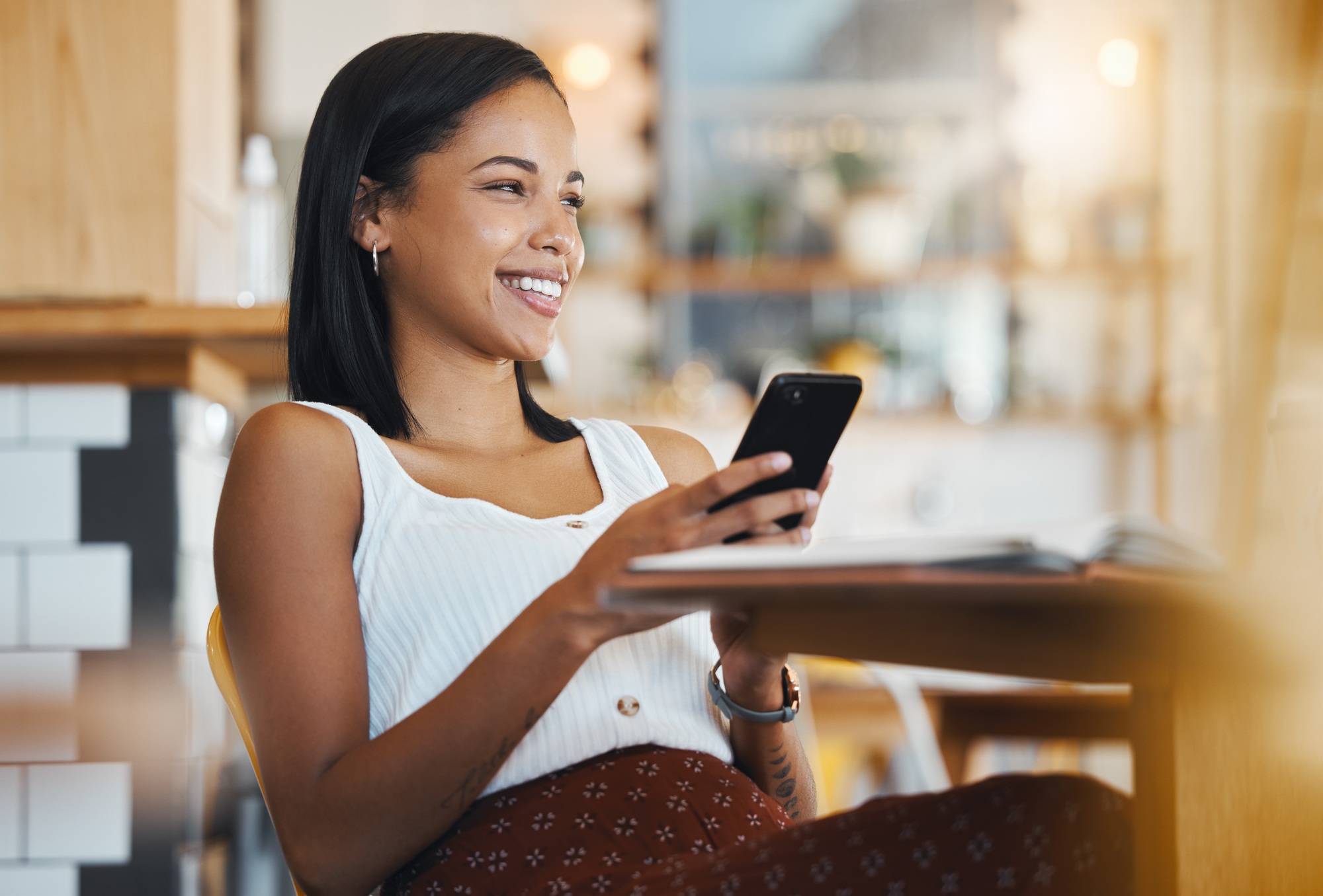 Relaxing, texting a message or browsing social media on a phone by a young female student smile in