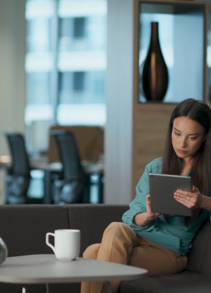 Serious woman reading tablet email at open space. Director lady typing computer