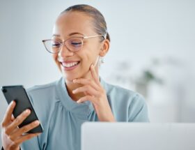 Smiling, excited and happy business woman texting, browsing and reading notification on phone with