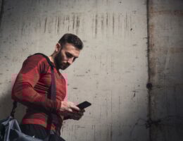 Sportsman typing a text message