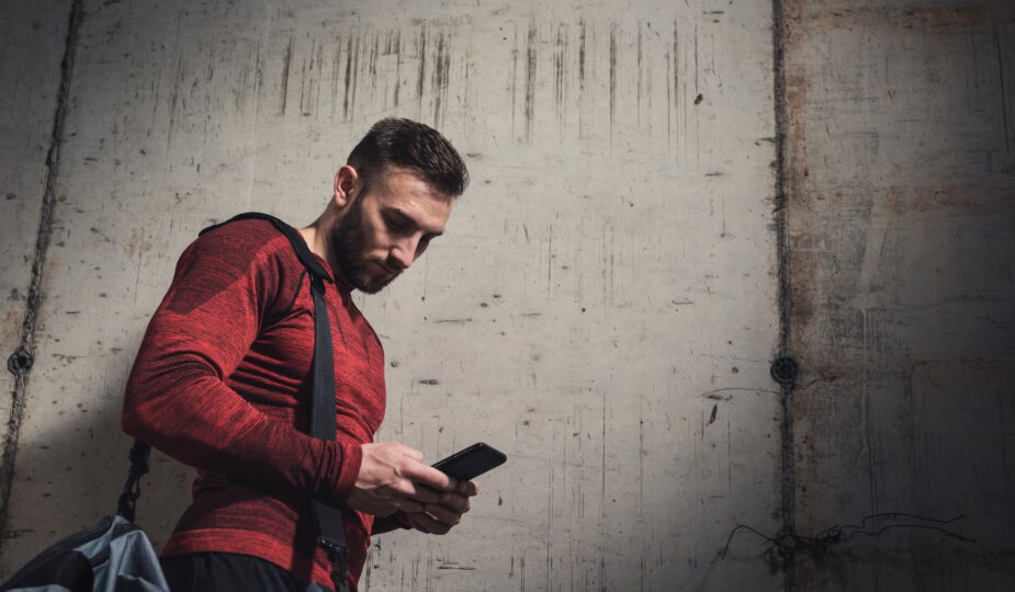 Sportsman typing a text message