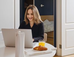 Happy woman chatting online from home