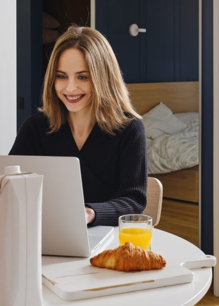 Happy woman chatting online from home