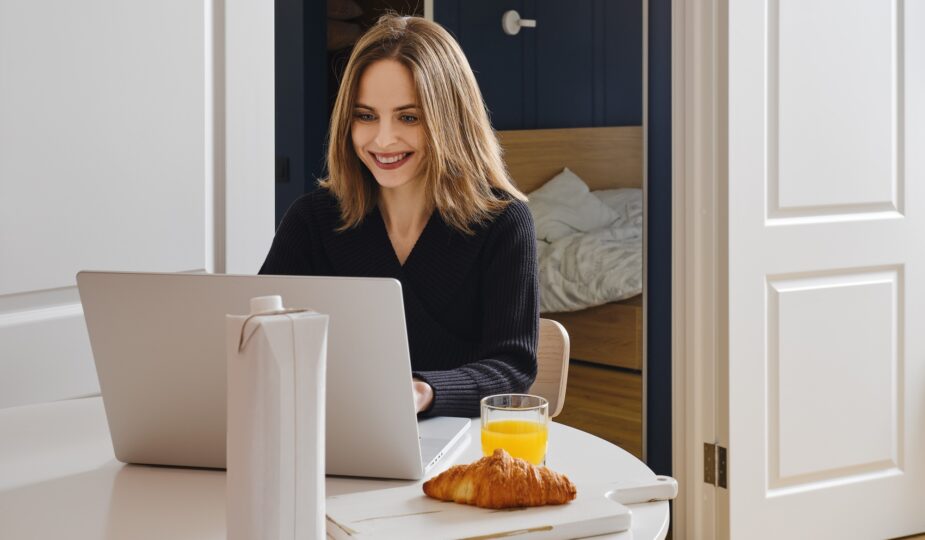 Happy woman chatting online from home