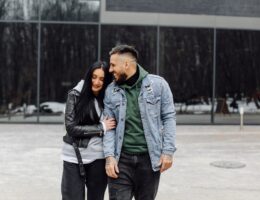 Outdoor happy couple in love posing near cafe