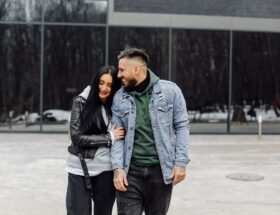 Outdoor happy couple in love posing near cafe