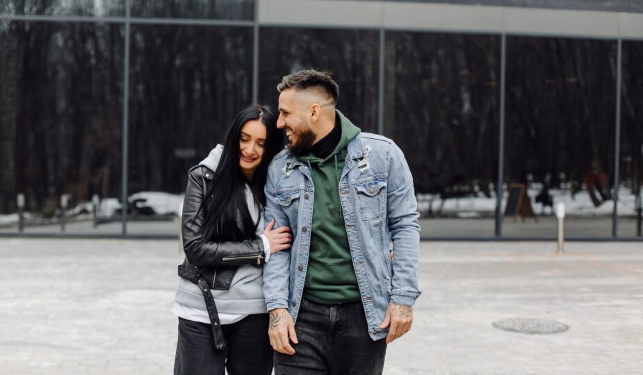 Outdoor happy couple in love posing near cafe
