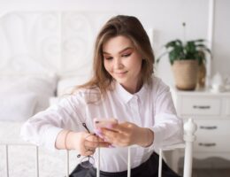 Young businesswoman reading news or sending text message